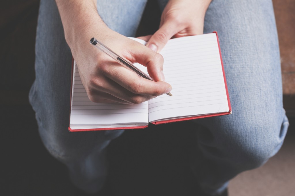 Man writing in notebook