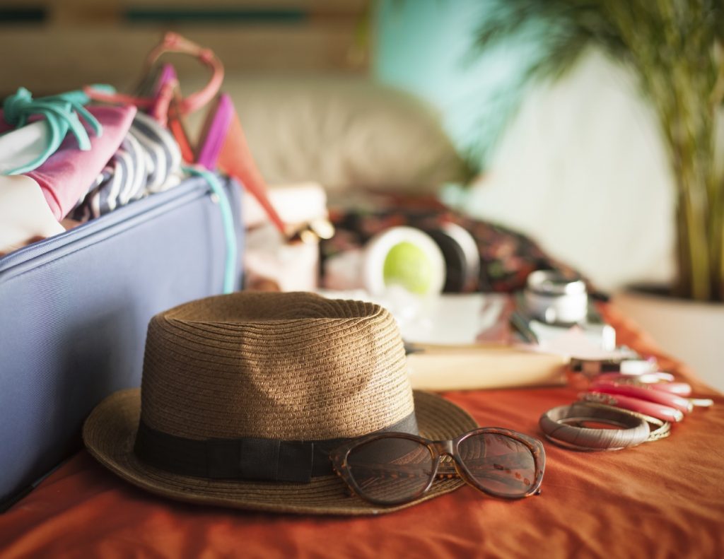 bedroom full of things ready to be taken on holiday