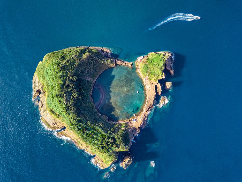 Azores aerial panoramic view. Top view of Islet of Vila Franca do Campo. Crater of an old underwater volcano. San Miguel island, Azores, Portugal. Heart carved by nature. Bird eye view.