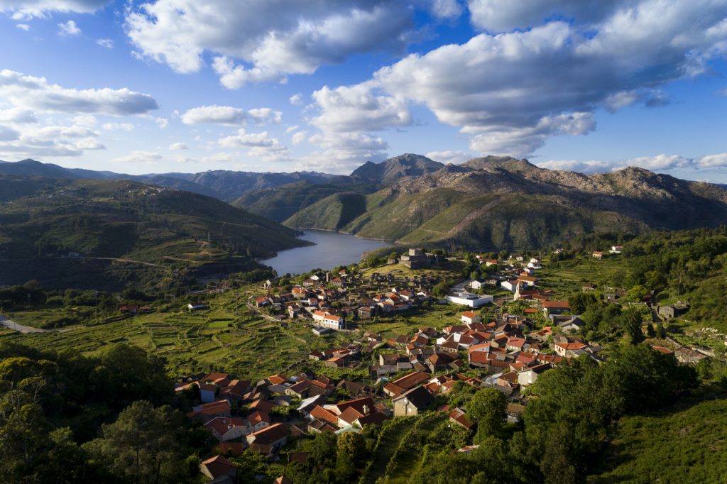 Aerial panoramic view of the historic village of Lindoso, with the surroundings mountains and lake, at the Peneda Geres National Park